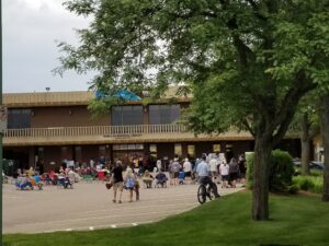 Group of people standing and sitting in front of McMillan Memorial Library
